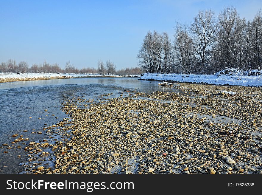 Frost rocky river in winter sunny morning