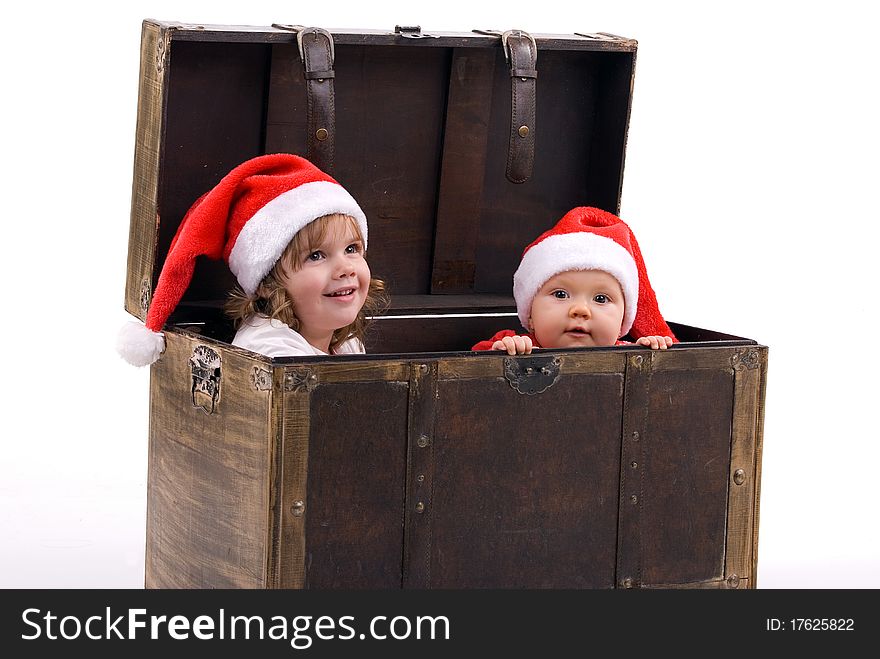 Girls dressed as Santa Claus sitting in a box. Girls dressed as Santa Claus sitting in a box.