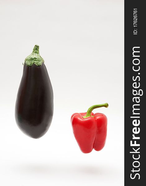 Eggplant and pepper on white background