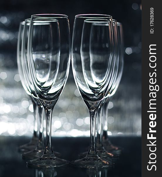 Empty champagne glasses on a green background