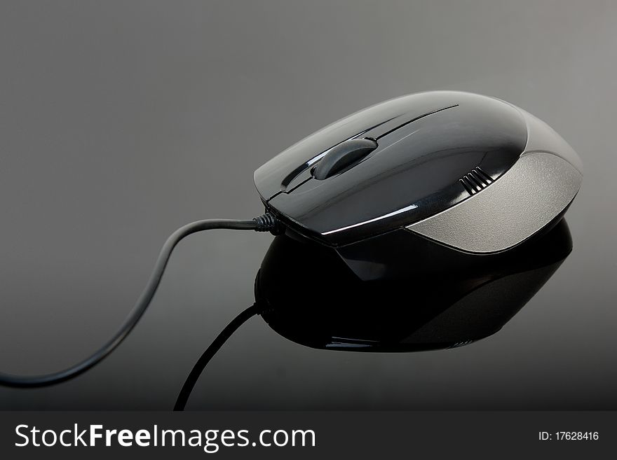 Close-up of black computer mouse over black background