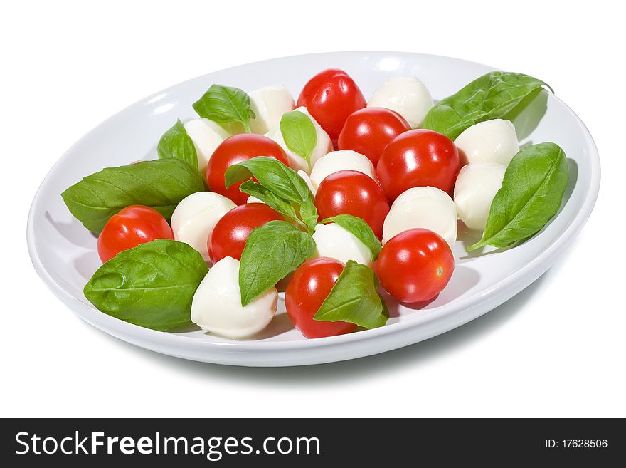 Salad with mozzarella and tomatoes on white background