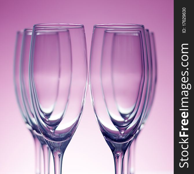 Empty champagne glasses on purple background