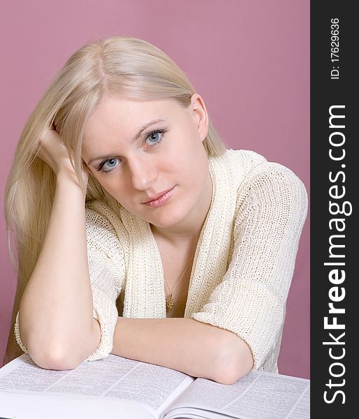 Studio portrait of teenage girl reading book. Studio portrait of teenage girl reading book