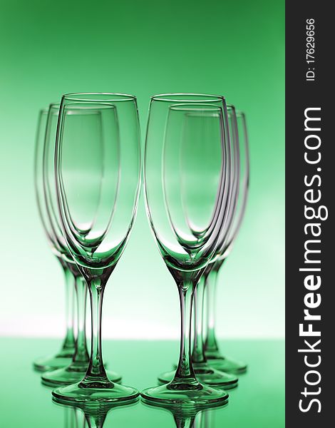 Empty champagne glasses on a green background