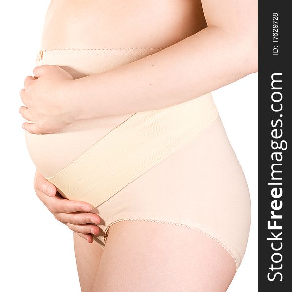 Pregnant woman holding her belly on white background