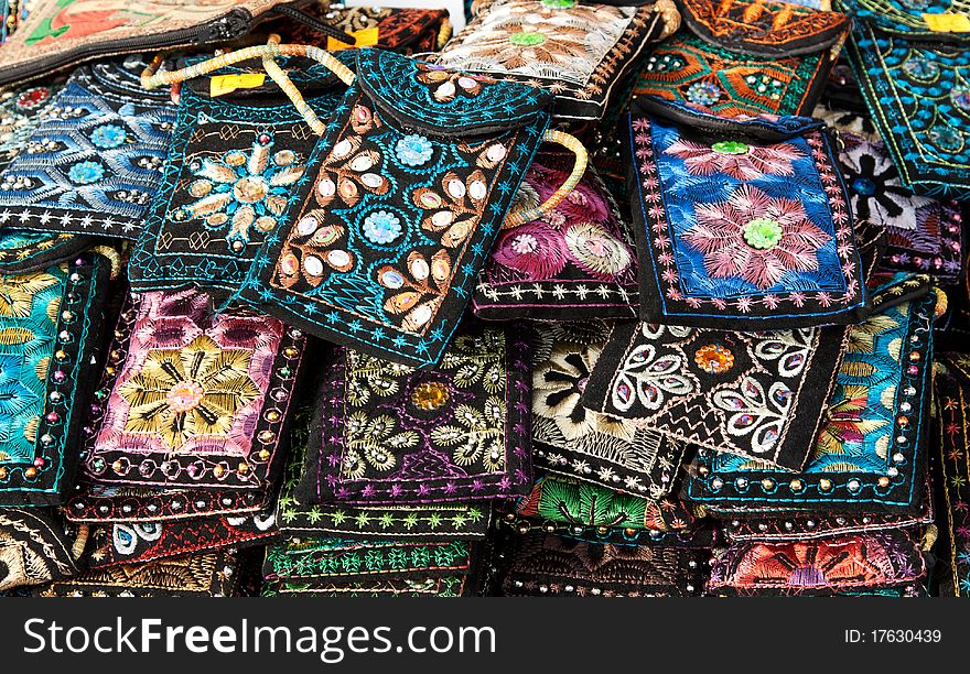 Embroidered oriental patterned purses stacked background in the bazaar