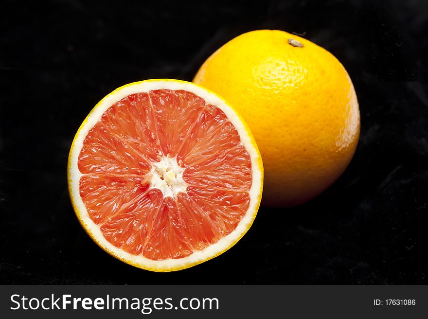 Two perfectly fresh oranges isolated on black