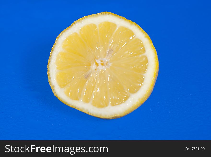Perfectly fresh lemon isolated on blue