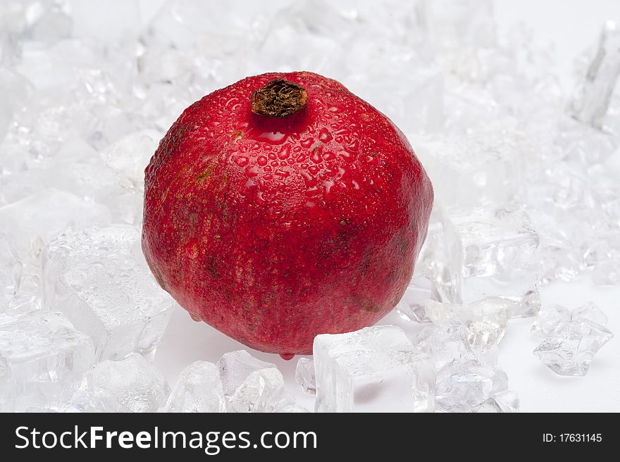 Fresh pomegranate on the ice background
