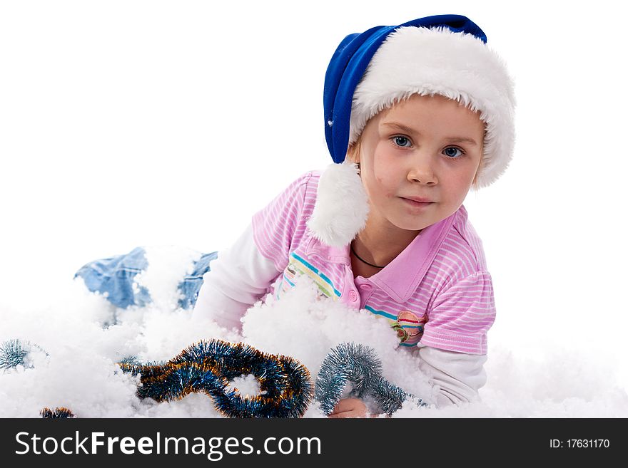 Beautiful girl in Santa's hat in tinsel and artificial snow isolated on white