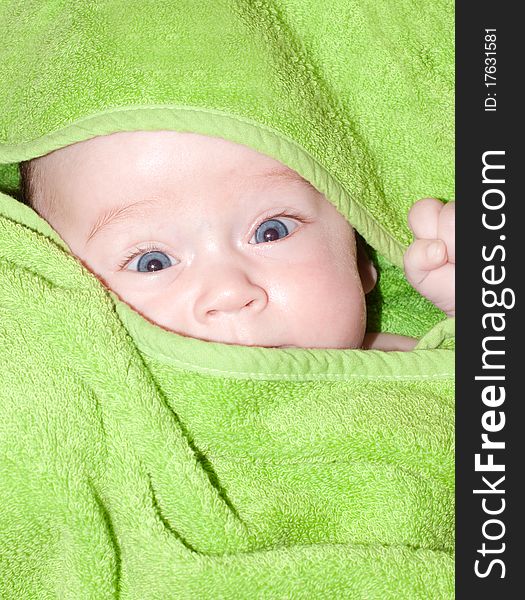 Baby looking out from under blanket. Baby looking out from under blanket.