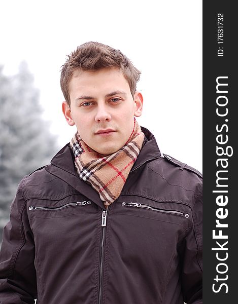Outdoor winter portrait of a beautiful young man