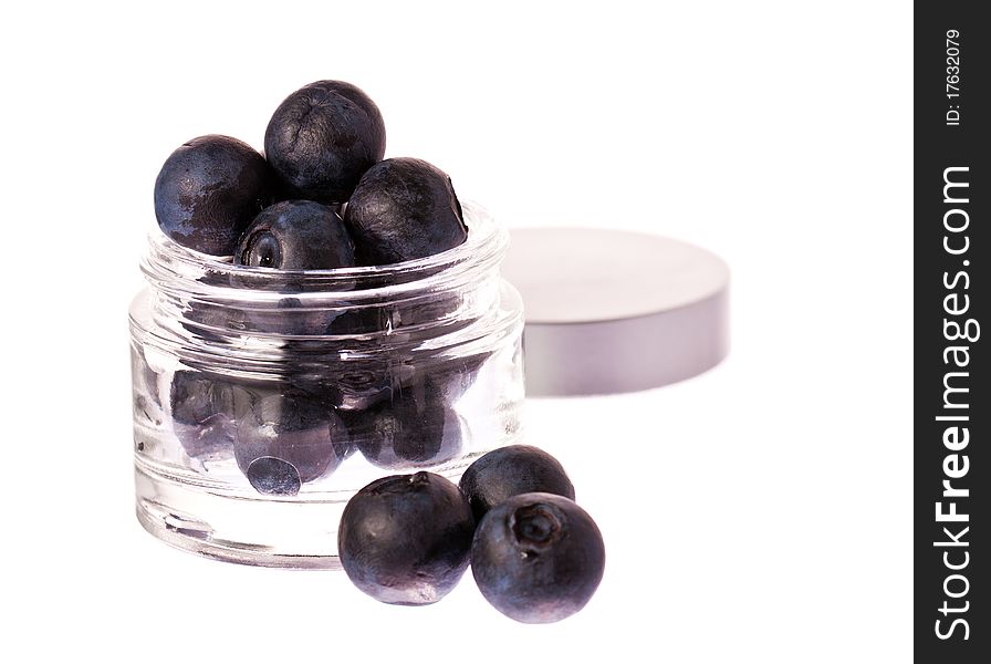 Fresh blueberries in a glass beauty cream jar. Isolated over white with clipping path. Fresh blueberries in a glass beauty cream jar. Isolated over white with clipping path.