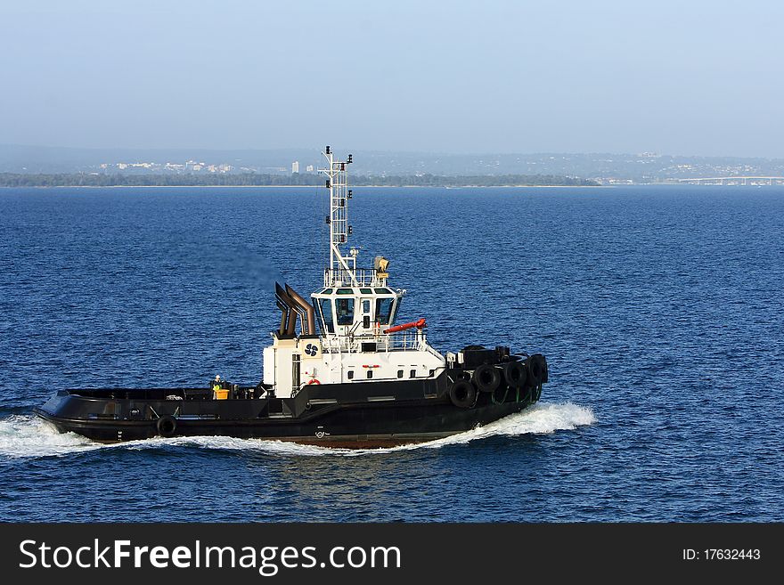 Sea tugboat under power on the sea. Sea tugboat under power on the sea.