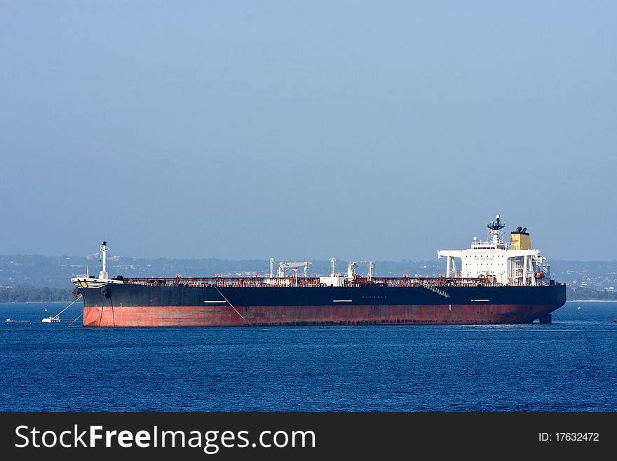 Oil supertanker ship moored in harbour. Oil supertanker ship moored in harbour.