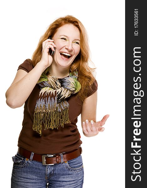 Red-haired adult woman on white background emotionally speaking the mobile cell phone. Red-haired adult woman on white background emotionally speaking the mobile cell phone