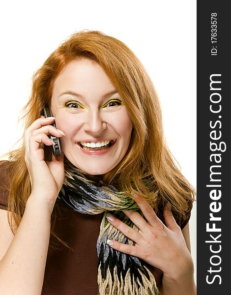 On white background Adult red-haired woman emotionally talking on the phone. On white background Adult red-haired woman emotionally talking on the phone