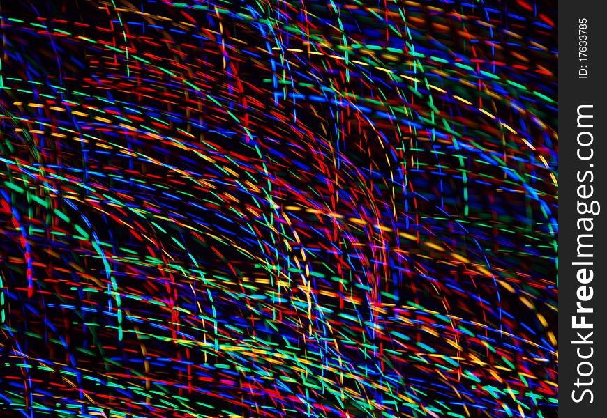 Abstract light patterns created with camera motion and colorful christmas lights.