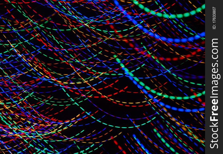 Abstract light patterns created with camera motion and colorful christmas lights.