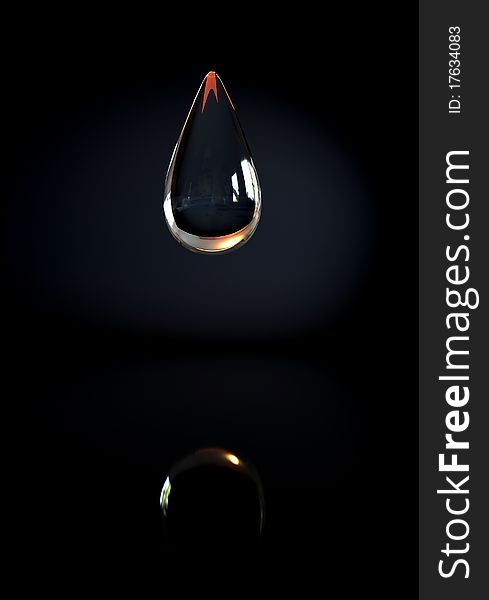 A drop of water on a black background with reflection