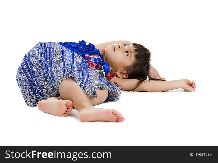 Cute little girl laying on the floor and looking up to the ceiling isolated on white background