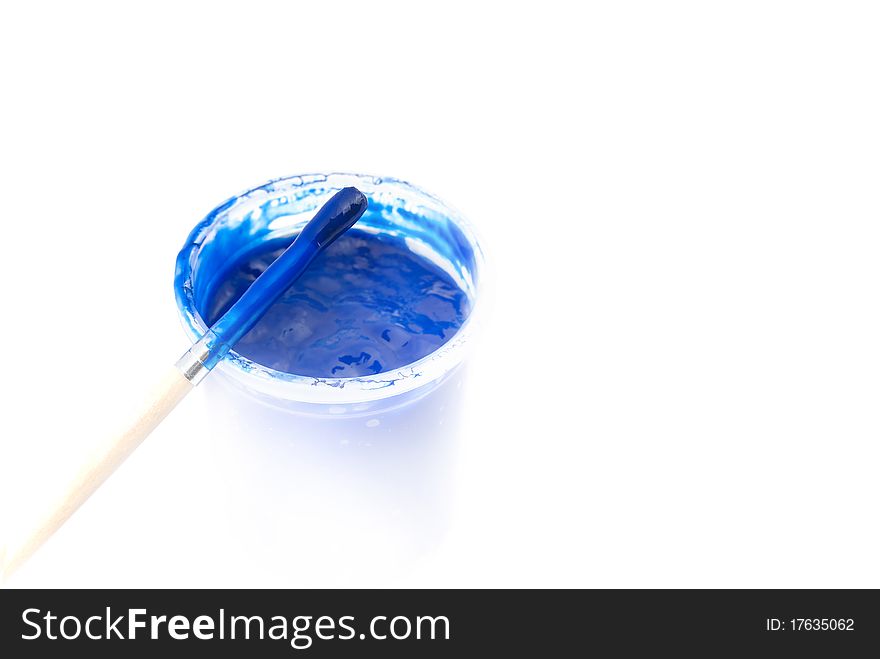 Jar with a blue paint and a brush, are isolated on a white background