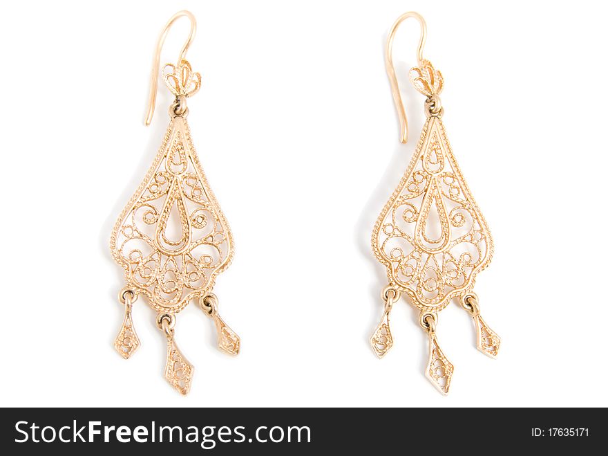 Graceful gold earrings, is isolated on a white background