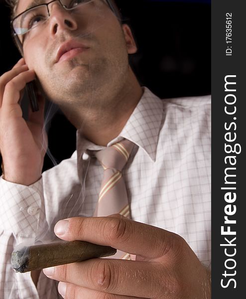 Businessman smoking cigar