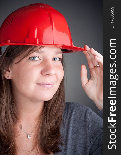 Portrait of young architect wearing red hardhat