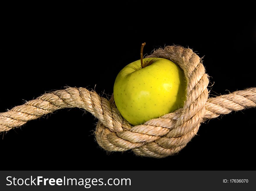 Green apple tided with rope- healthy food concept