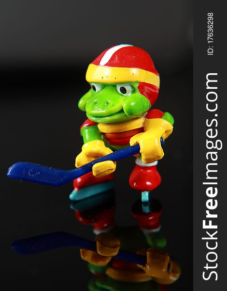 Frog toy, playing ice hockey