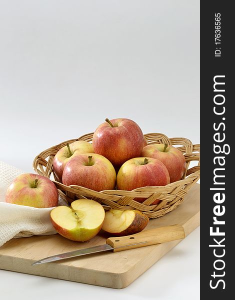 Fresh red apples in a basket. White background.