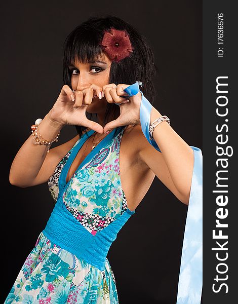 A girl in a blue evening dress on a black background. A girl in a blue evening dress on a black background