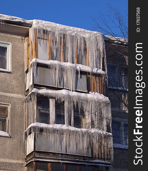 Icicles on a roof. The iced over balconies. Icicles on a roof. The iced over balconies.