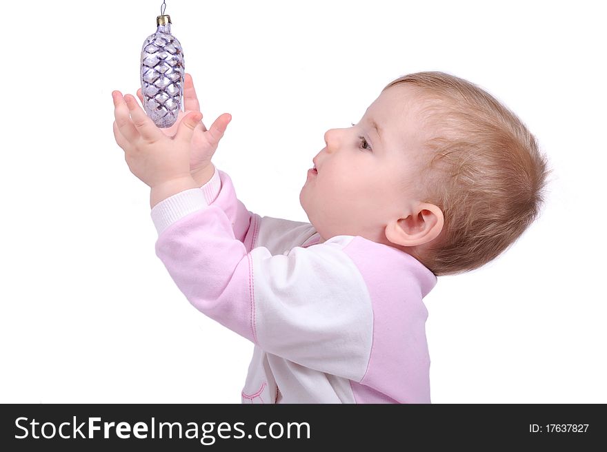The child lasts hands to a fur-tree toy. The child lasts hands to a fur-tree toy