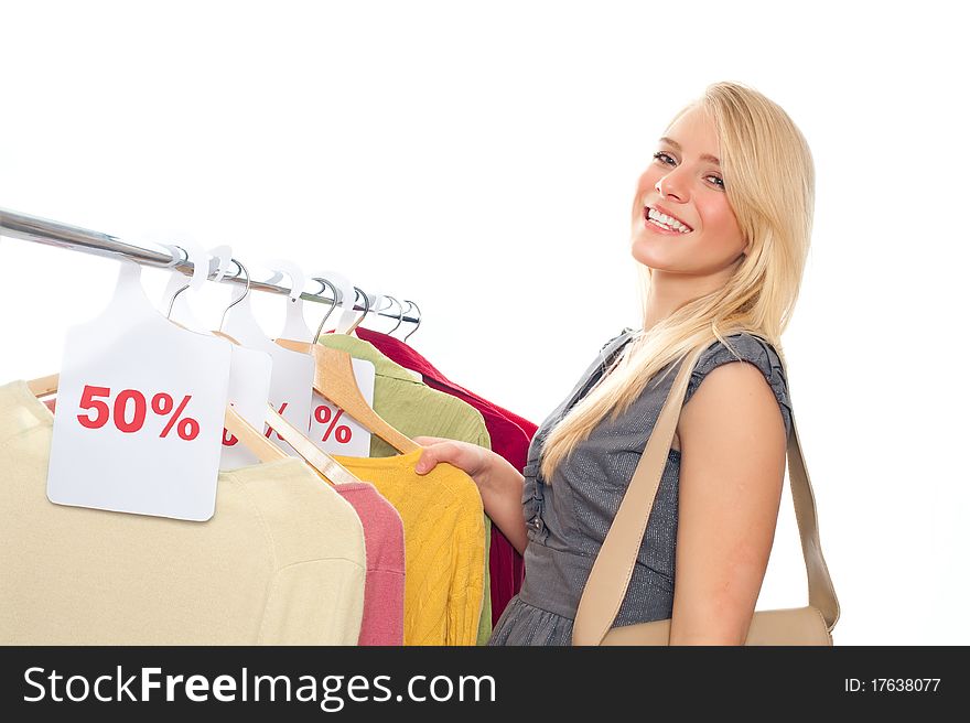 Young happy woman in clothes store on a white background