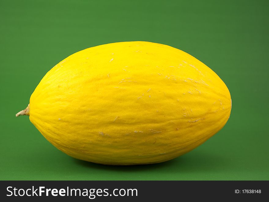 Yellow melon isolated on green background