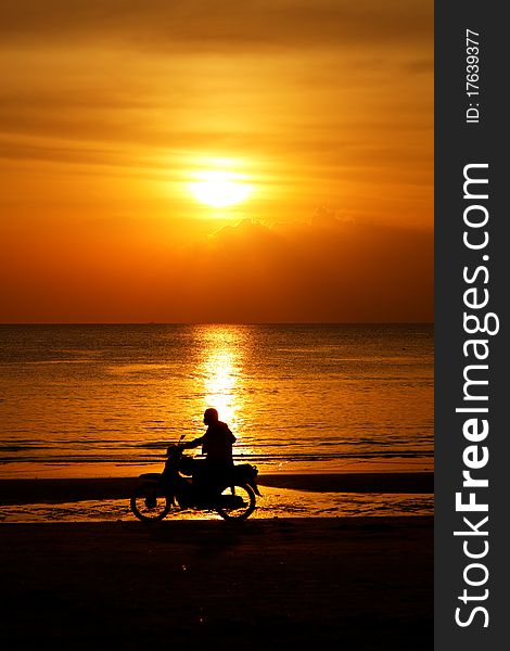 Motorcycling in the sunset at beach on Langkawi island, Malaysia. Motorcycling in the sunset at beach on Langkawi island, Malaysia