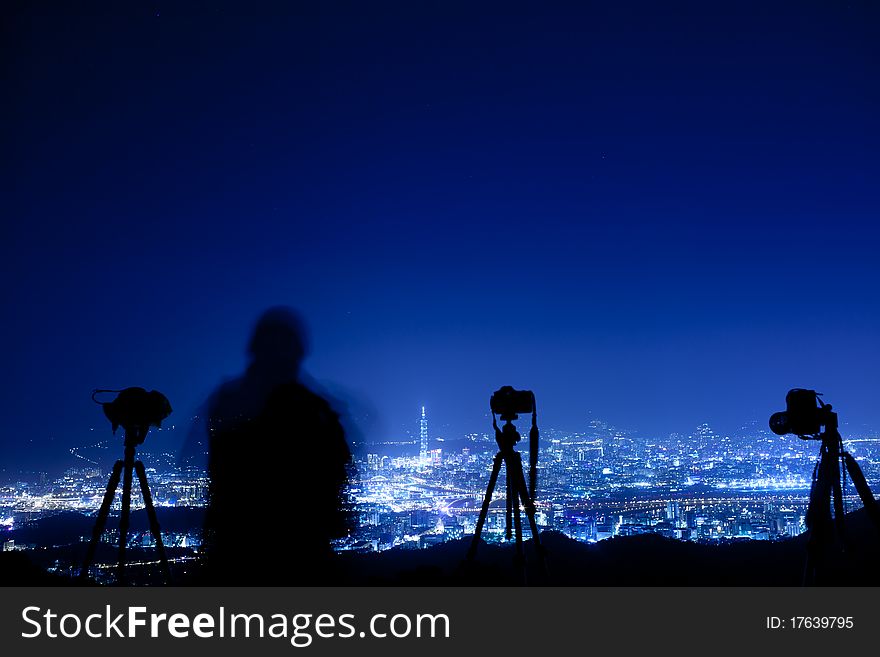 Night scenes of the Taipei city with person take picture (back view), Taiwan for background or others purpose use. Night scenes of the Taipei city with person take picture (back view), Taiwan for background or others purpose use