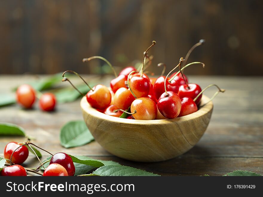 Sweet cherry in a wood plate. Fresh fruits