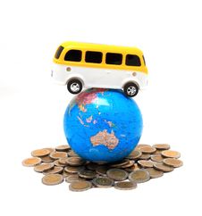Globe And Car On The Pile Of Coins - Isolated Royalty Free Stock Photography Globe And Car On The Pile Of Coins - Isolated Royalty Free Stock Photography