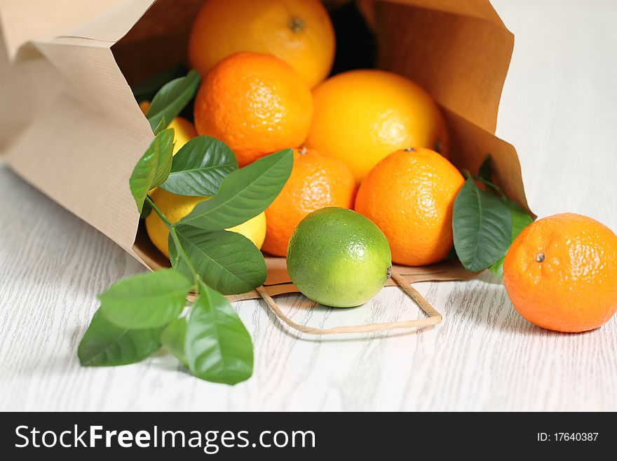 Fresh citrus fruits in the package on a wooden table