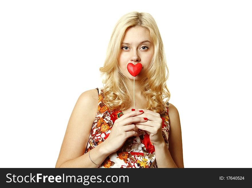 Close-up of a beautiful young woman with a red heart. Isolated on a white background. Close-up of a beautiful young woman with a red heart. Isolated on a white background