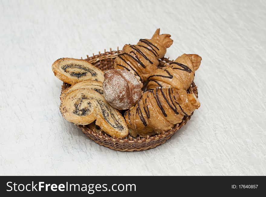 Basket with fresh pastry on white background. Basket with fresh pastry on white background