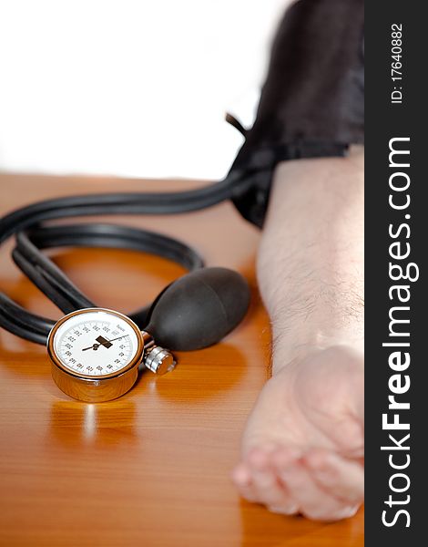 Measuring blood pressure, lying on a doctor`s table. Measuring blood pressure, lying on a doctor`s table