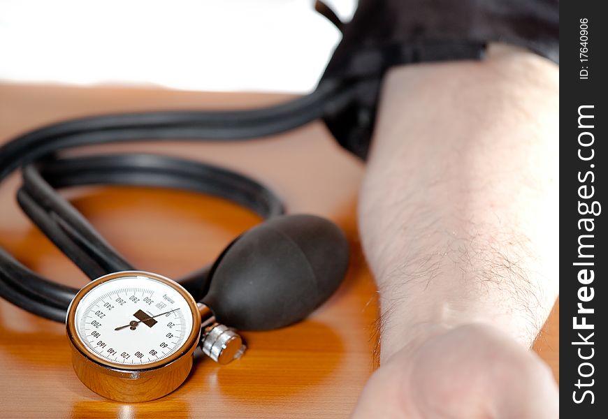 Close view of a blood pressure gauge at a man`s am. Close view of a blood pressure gauge at a man`s am