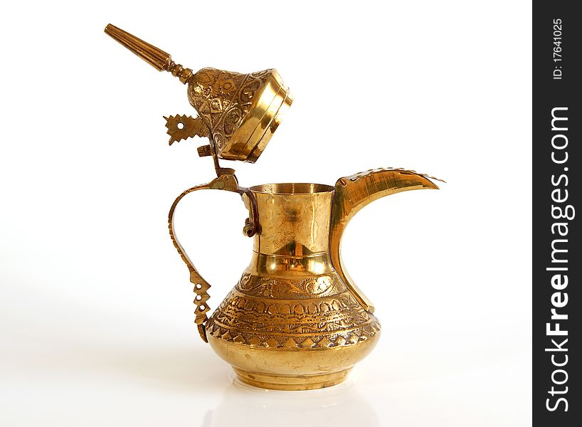 Copper jug with a traditional Arabic ornaments on a white background