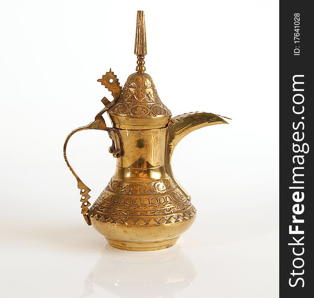 Copper jug with a traditional Arabic ornaments on a white background