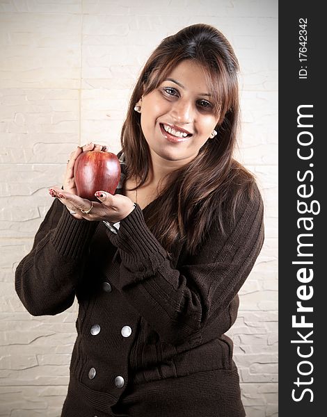 Beautiful girl holding ripe apple in her hand. Beautiful girl holding ripe apple in her hand.